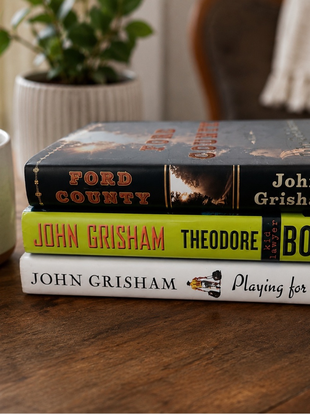 Stack of John Grisham Hardcover Books - Black, Lime, White Spines